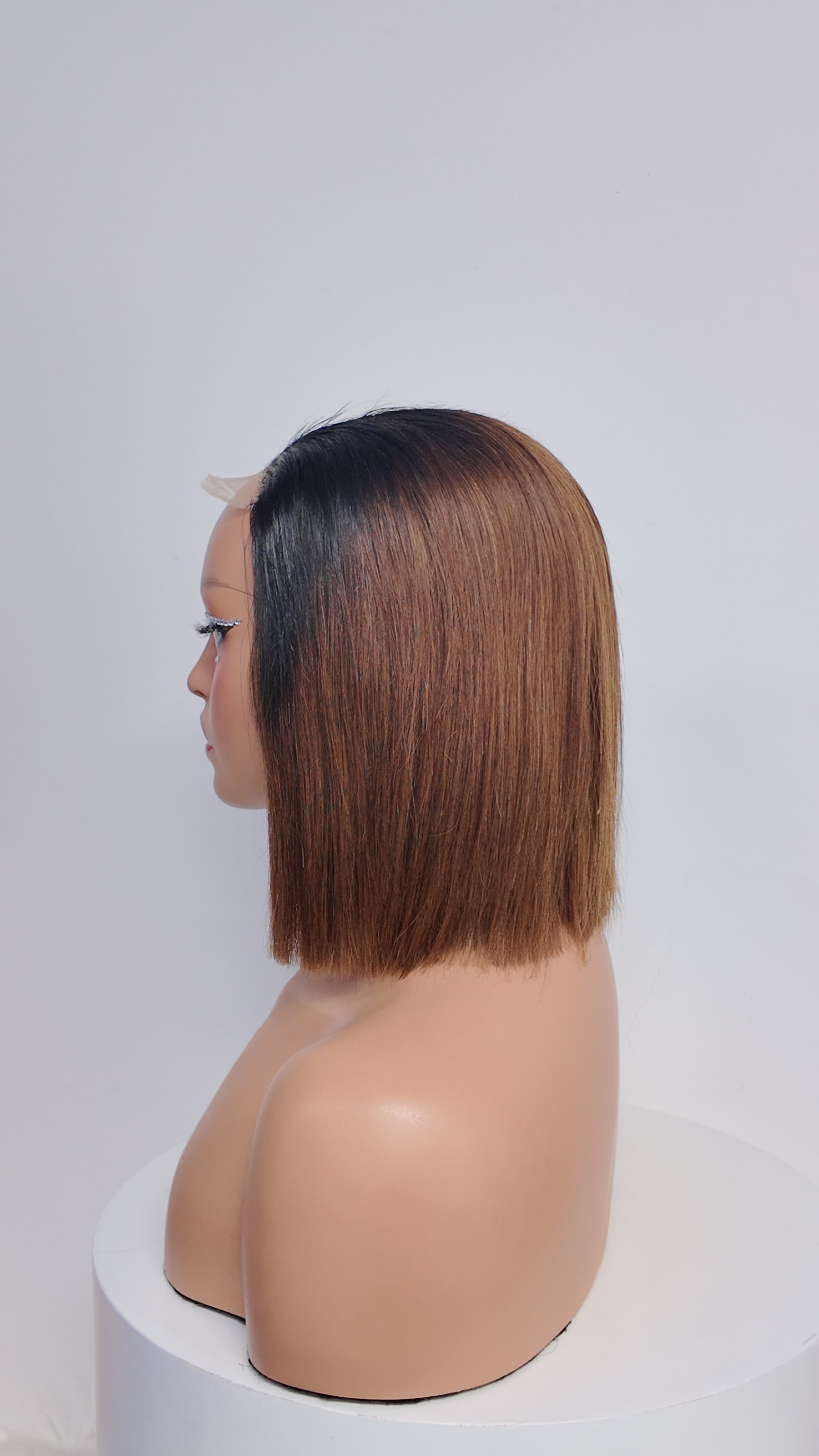 Side view of Worry Freeshop black root brown straight bob human hair wig
