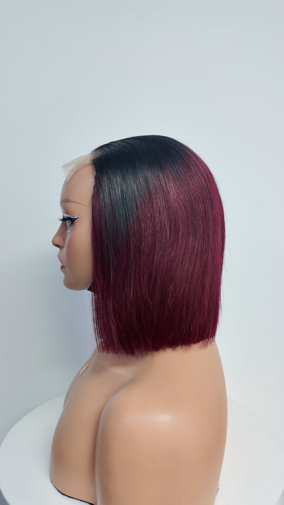 Side view of Worry Freeshop black root burgundy straight bob human hair wig