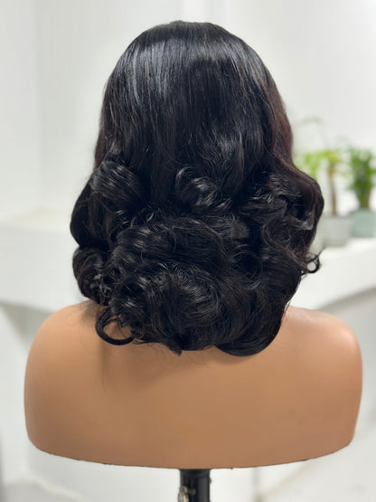 Back view of natural black retro curl 5x5 lace human hair wig